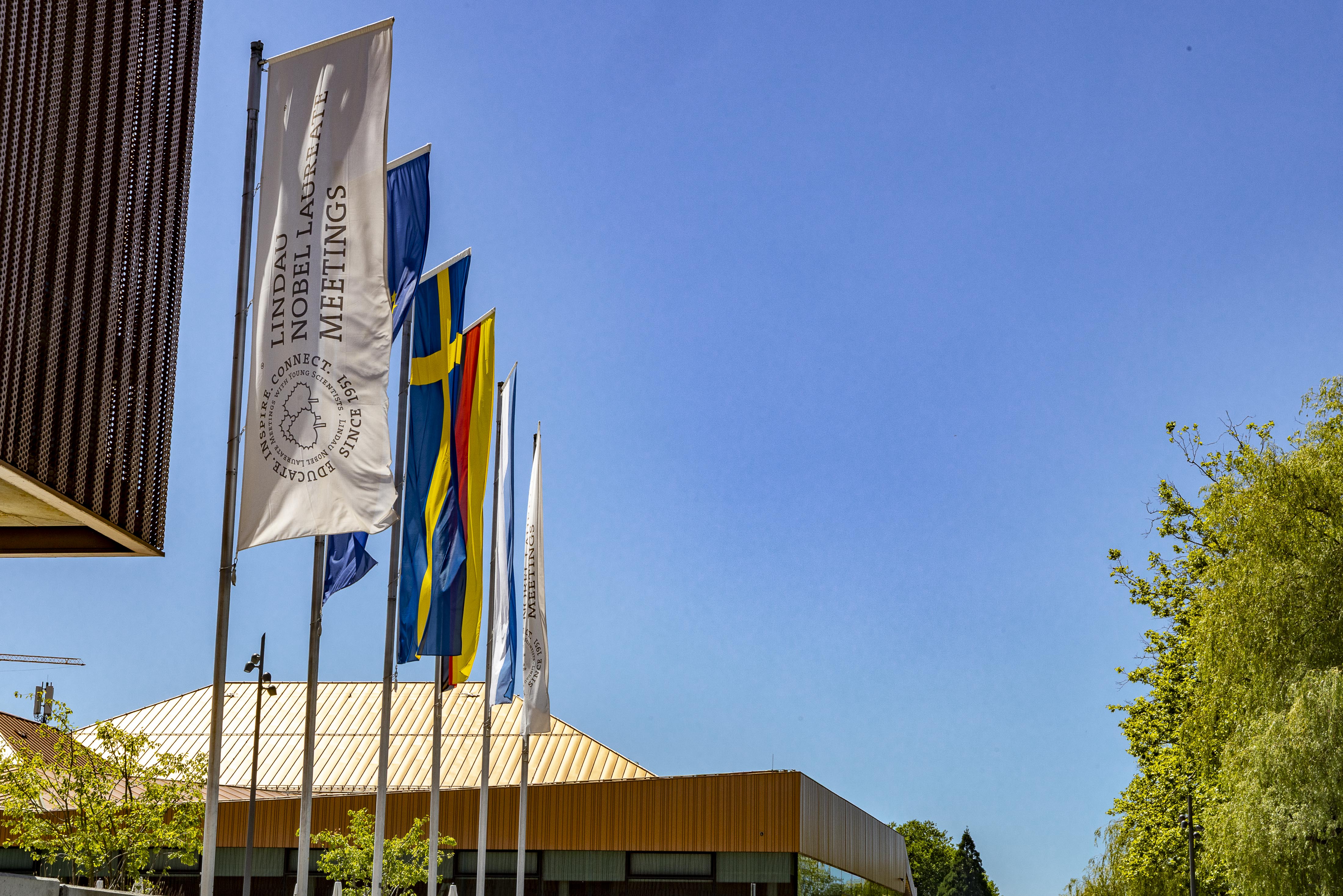 Six flags blow in the wind outside the 74th Lindau Nobel Laureate Meeting in Chemistry, source: Lindau Nobel Flickr 