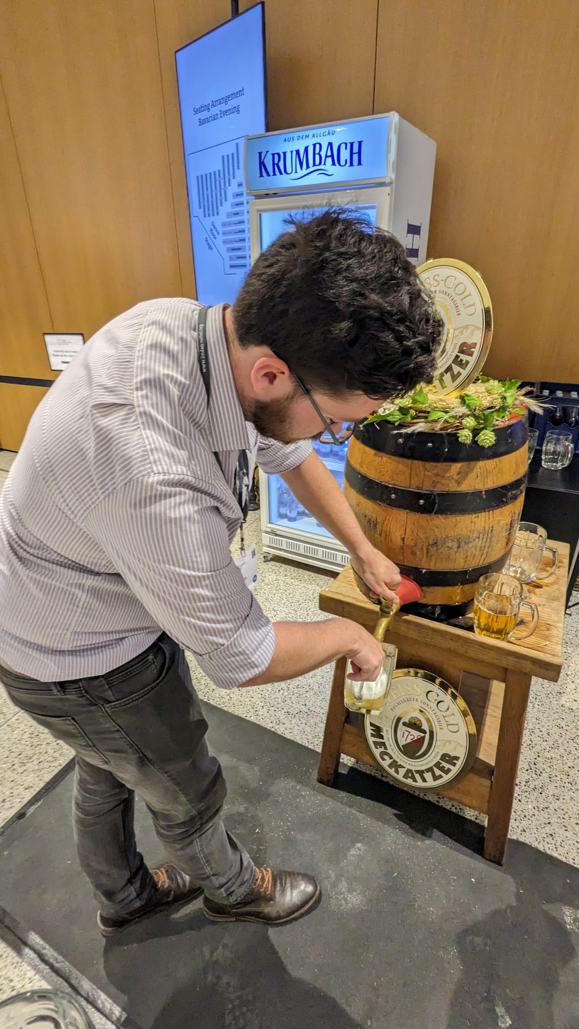 David pours a beer from a keg at the Bavarian hospitality evening.