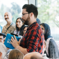David asking a question during an Agora session with Reinhard Genzel, Physics 2020, source: Lindau Nobel Flickr 